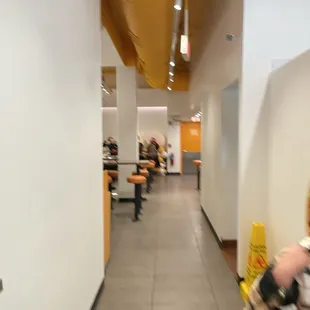 a woman walking down a hallway