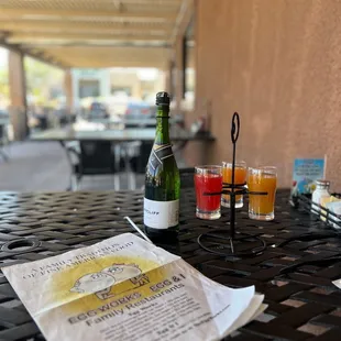 a bottle of beer and two glasses on a table