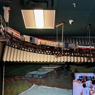 The train traveling below the ceiling.