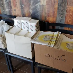 Chairs piled with boxes, instead of left cleared for customers to have somewhere to sit while waiting.