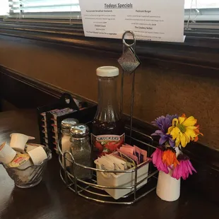 a table with a basket of eggs and a vase of flowers