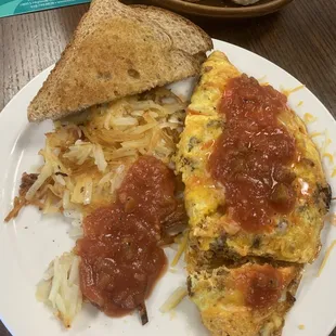 Meat lovers Omelette, Hash Browns, and wheat toast.