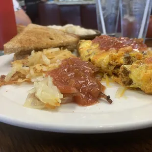 Meat lovers Omelette, Hash browns, and wheat toast.
