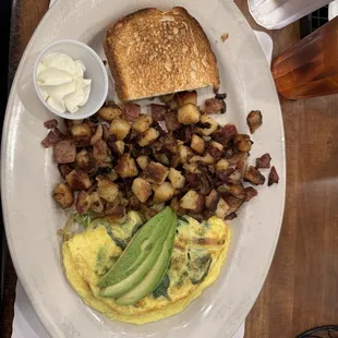 Make your own omelette with white toast. Made with peppers, onions, spinach, cheese, and avocado. Great!