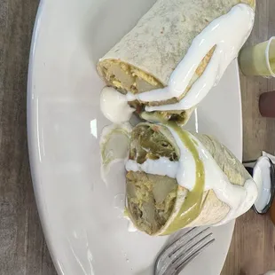 Breakfast burrito with fresh crème and salsa.