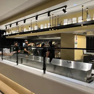 a restaurant kitchen with people preparing food