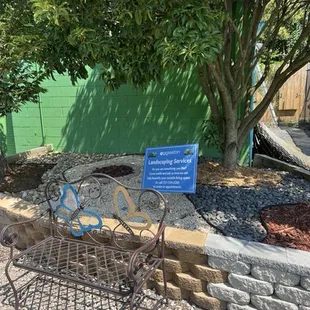 Quaint bench and information of landscaping services Eggleston provides