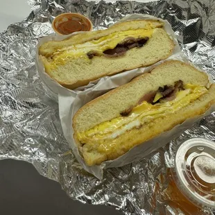 Bacon, egg, and cheese sandwich with sauce on the side (hot honey and house made hot sauce).