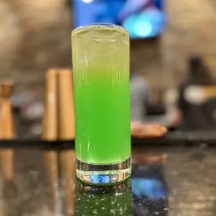 a glass of green juice