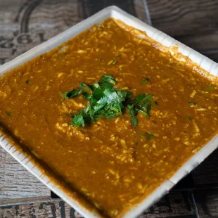 a square bowl of soup