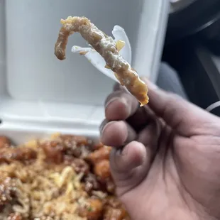 a hand holding a piece of food