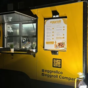 a yellow food truck parked in a parking lot