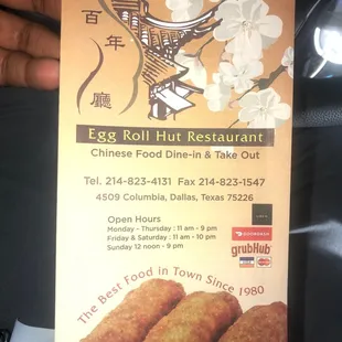 a hand holding a menu