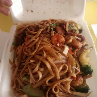 a take out box of noodles