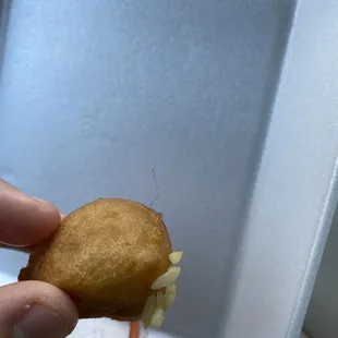 a hand holding a piece of food