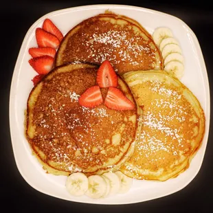 a plate of pancakes and strawberries