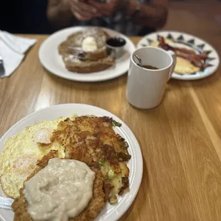 a plate of pancakes and a cup of coffee