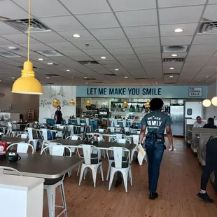 a woman walking through a restaurant