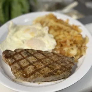 a steak and hash browns on a plate
