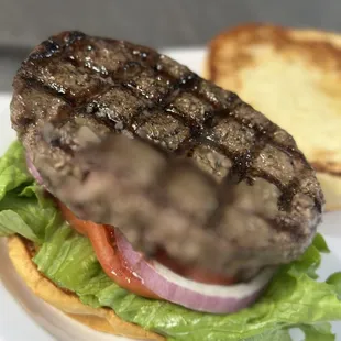a hamburger with lettuce and tomato