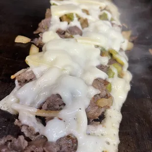 meat and cheese on a flat bread