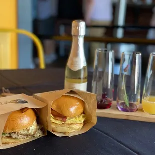 two sandwiches and a glass of juice