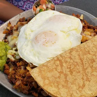 Mexicana skillet ($17): 2 eggs, chorizo, jalapeno, cheese, guac, salsa, and sour cream over seasoned potatoes. Served with tortillas