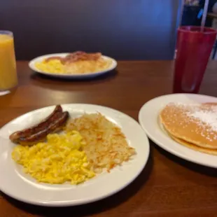 Chicken sausage, pancakes, eggs, bacon, eggs, sausage patties,hash browns, sweet tea, and orange juice