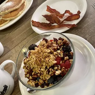 Yogurt and granola bowl with a side of bacon