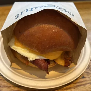 a breakfast sandwich in a paper bag