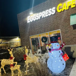 a snowman and reindeer outside