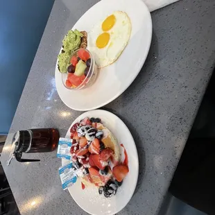 two plates of breakfast food