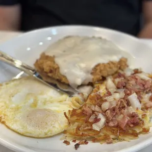 Chicken fried steak, hash browns, and over easy eggs.