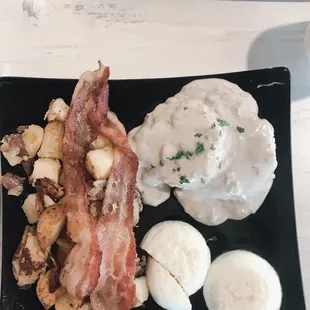 Biscuit and gravy special w 2 egg bacon and seasoned red potatoes