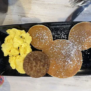 Kids meal with eggs, sausage and a Mickey shaped pancake.