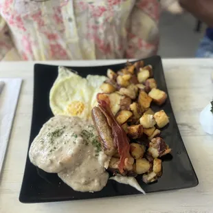 Biscuits &amp; Gravy eggs over medium potatoes sausage and bacon
