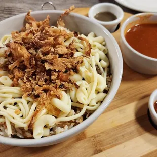 Koshari - A mixture of pasta, rice, lentils, chickpeas, and onions. Add the sauce, and it tastes like you are eating Italian spaghetti.