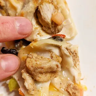 a hand holding a piece of food