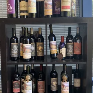 a shelf of wine bottles