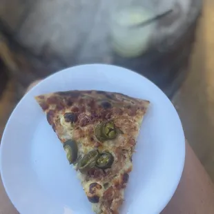 a slice of pizza on a plate
