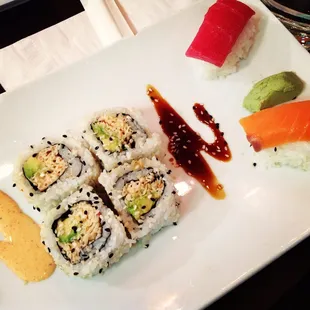 a plate of sushi and sauce