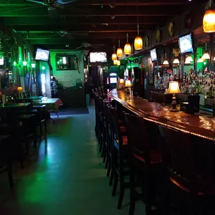 a bar with green lights