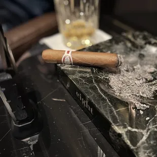 a cigar and a glass of whiskey