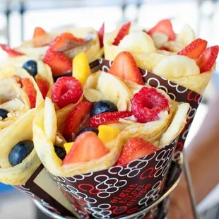 a person holding a bouquet of fruit