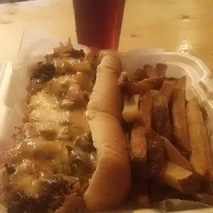 ows a plate of food and a glass of beer