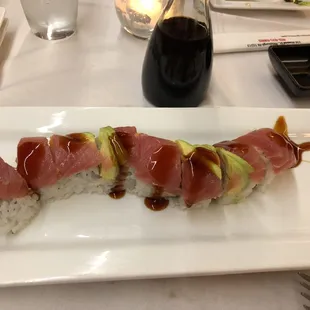 a sushi roll on a white plate
