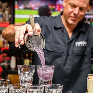 a bartender pouring a drink