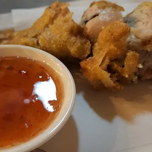 a plate of food with dipping sauce