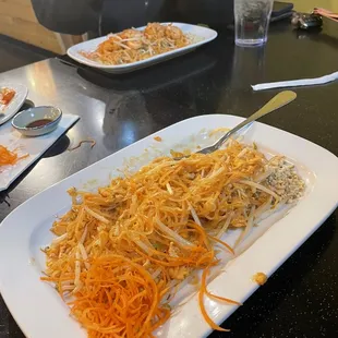 a person eating a plate of noodles