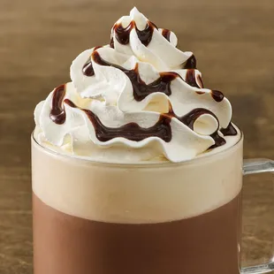 a cup of coffee with whipped cream and chocolate